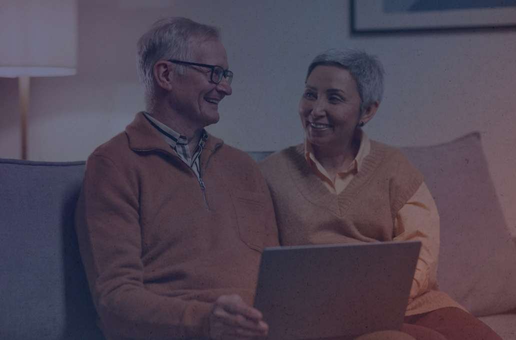 Butte Living Elderly couple using a laptop together.